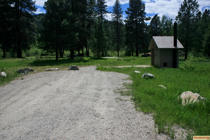 The outhouse in Site 100 in Baumgartner Campground info sign.