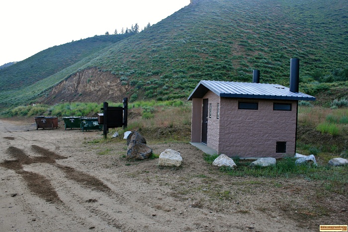 Curlew Creek Boat Ramp has a vault style outhouse and notice the garbage dumpsters.