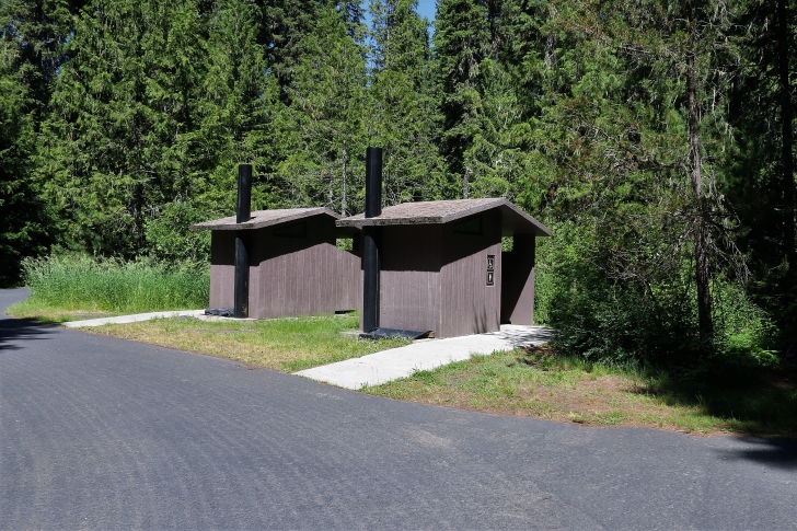 A picture of a set of vault style outhouses located at the bottom end of Giant White Pine Campground.