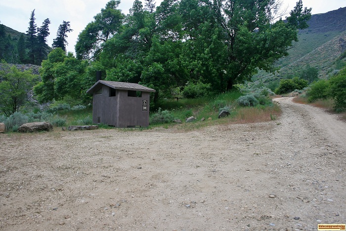The outhouse and camping sites are located across the road.