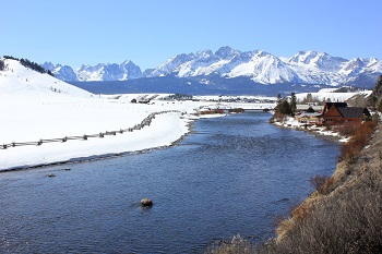 The Salmon River in the winter with the Sawtooth Mountains and Stanley, Idaho in the background.