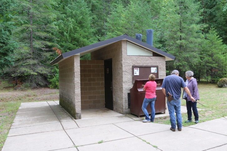 There is a vault style outhouse and garbage can in the parking area at Watson Falls - Oregon.